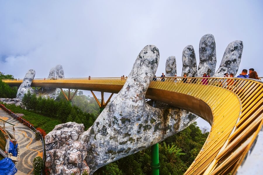 Golden Bridge in Ba Na Hills goes through the cloud.
