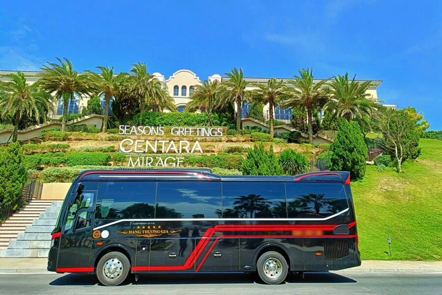 Luxury 29-seat bus parked in front of Centara Mirage Resort Mui Ne during a tour from Ho Chi Minh City