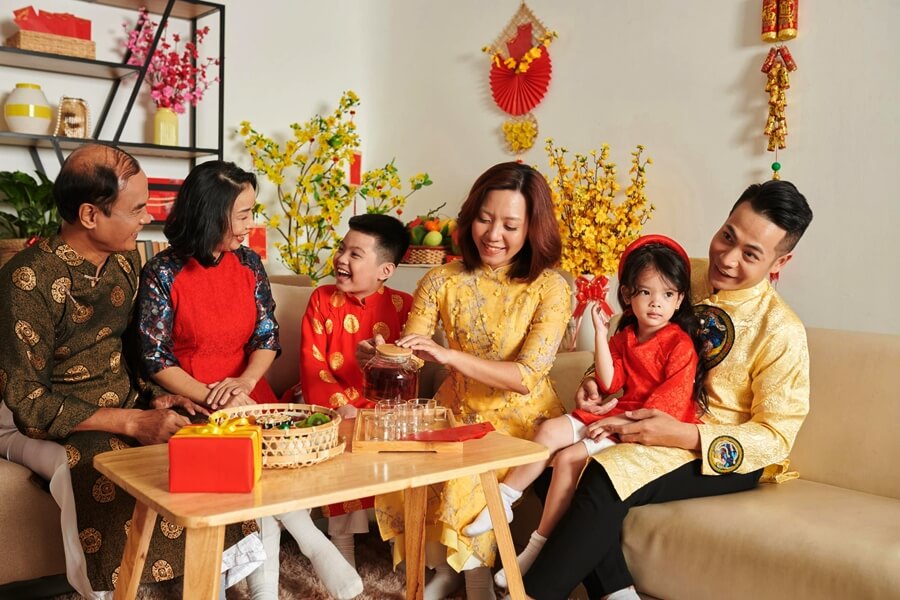 Vietnamese family gathering during Tet holiday, symbolizing traditional customs and family values