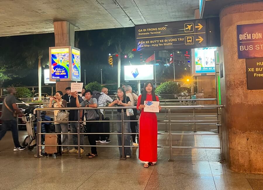 Staff holding a name sign to welcome guests at Tan Son Nhat Airport in Ho Chi Minh City