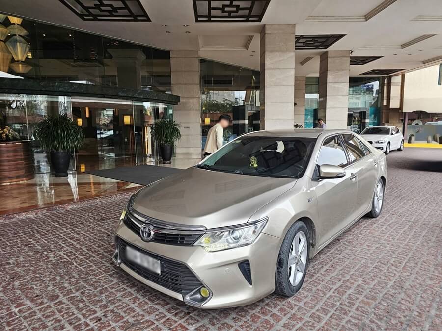 Private car with driver waiting outside a hotel for pickup in Hanoi