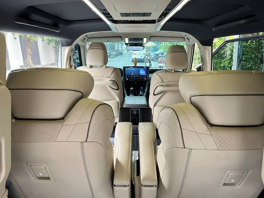 Luxury interior cabin of Toyota Alphard for rent in Ho Chi Minh City featuring premium dashboard and LED lighting
