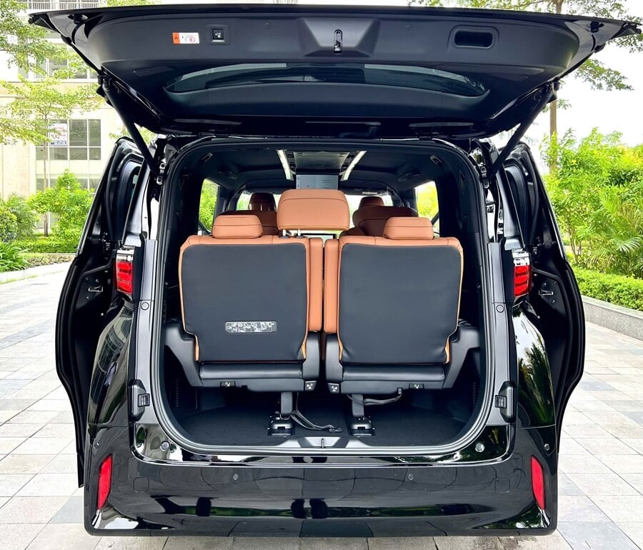 Rear view of Toyota Alphard with open trunk showing spacious luggage capacity for airport transfers