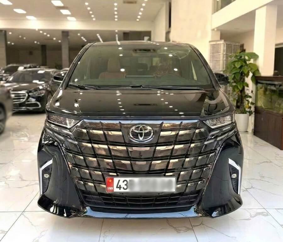 Front view of a black Toyota Alphard luxury MPV for rent in Da Nang, Vietnam
