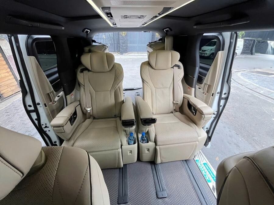 High-end leather Captain seats in Toyota Alphard with electric leg rests for VIP transport in Saigon