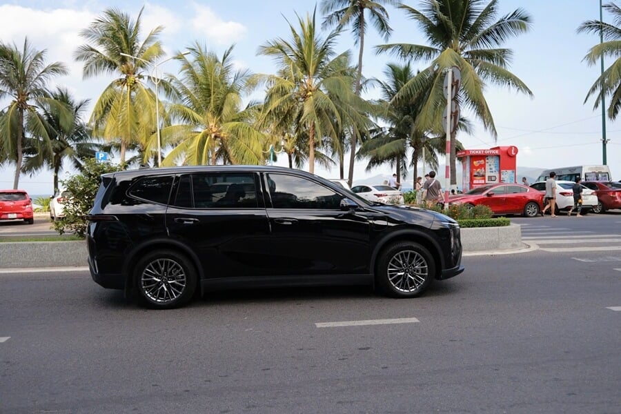 A 7-seater private car driving along Tran Phu Street in Nha Trang at the beginning of a two-day journey to Ho Chi Minh City via Mui Ne
