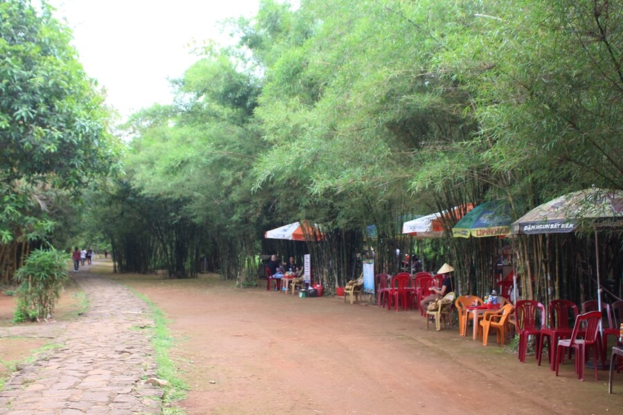 Travelers resting under bamboo trees near the entrance to the Vinh Moc Tunnels