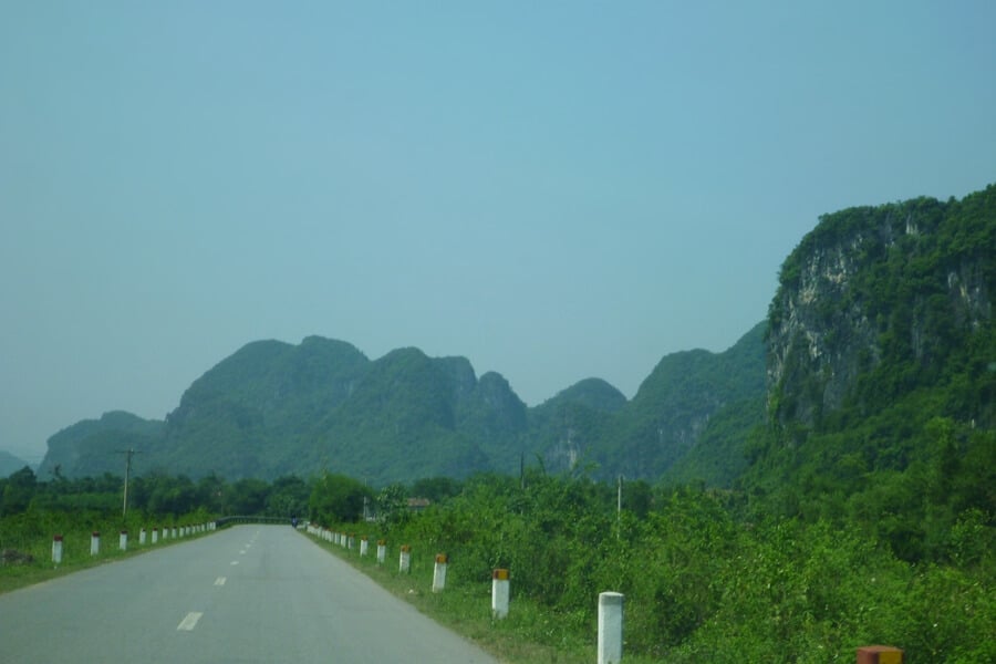 Two-lane road leading to Paradise Cave near Trooc Bridge