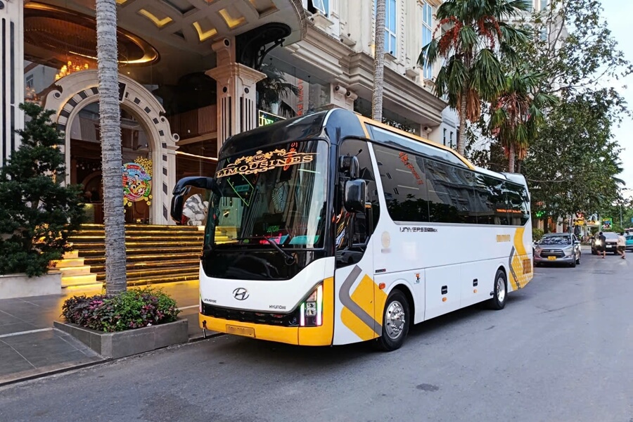 29-seat luxury limousine waiting at a hotel for conference transportation in Ho Chi Minh City