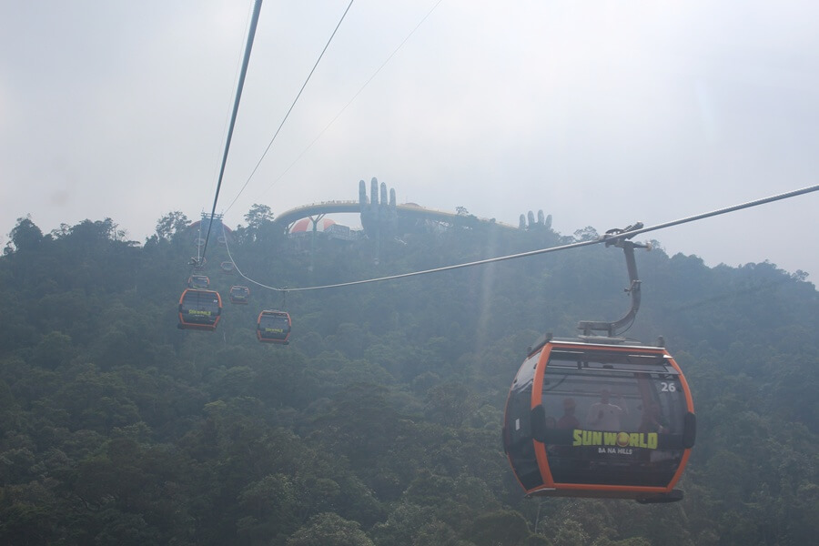 Cable car approaching Ba Na Hills with the Golden Bridge visible in the background