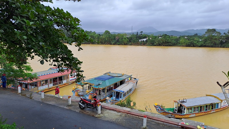 Dragon boats park on the river and in font of Thien Mu Pagoda