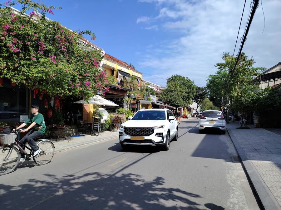 Private car driving on a street in Hoi An