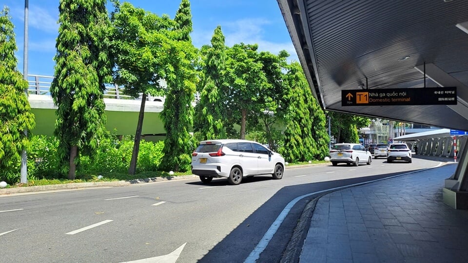 Three transport vehicles driving toward the domestic terminal at an airport in Vietnam