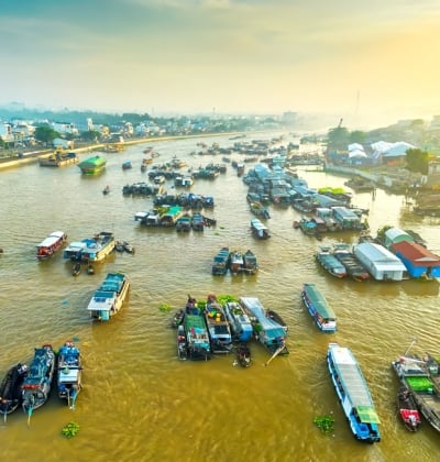 Visiting Cai Rang Floating Market at sunrise in Can Tho City, South Vietnam